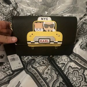 Karl Lagerfeld with his kitty cross body